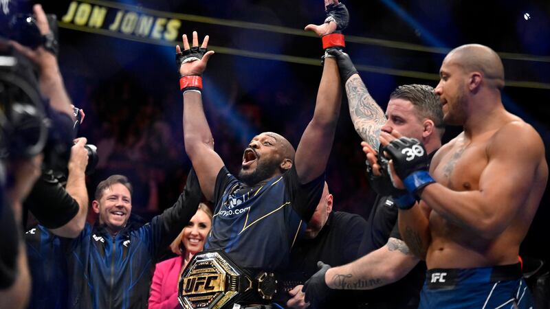 Jon Jones, center, celebrates after defeating Ciryl Gane in a UFC 285 mixed martial arts...