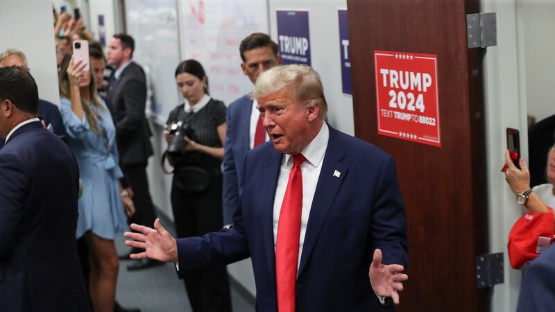 Former President Donald Trump speaks as he visits a Trump 2024 campaign office in Summerville,...