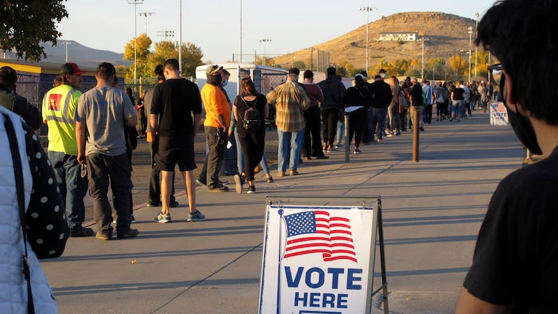 People wait to vote in-person at Reed High School in Sparks, Nev., prior to polls closing on...