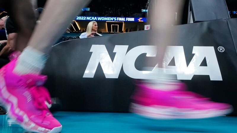 Players take the court before the start of a college basketball game in the semifinal round of...