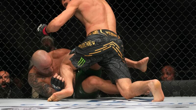 Islam Makhachev of Russia, on top, battles Alex Volkanovski of Australia in the UFC...