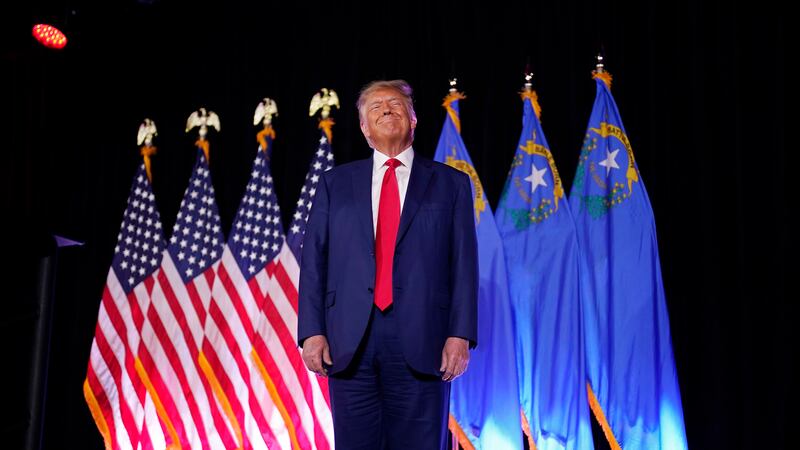 Former President Donald Trump stands on stage before speaking at a campaign event, July 8,...