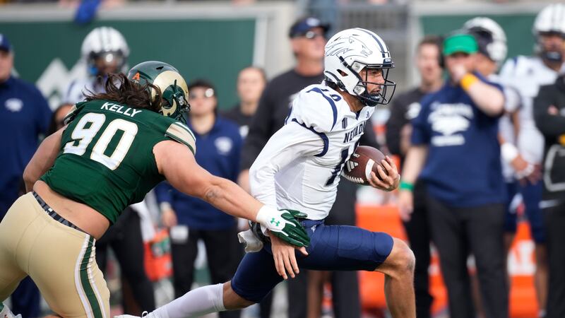 Colorado State defensive lineman Grady Kelly, left, tackles Nevada quarterback AJ Bianco after...