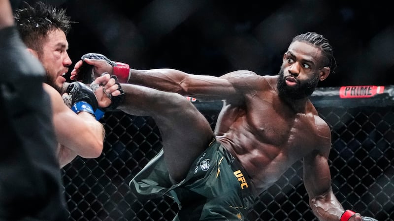 Aljamain Sterling, of Jamaica, kicks Henry Cejudo during the fifth round of a bantamweight...