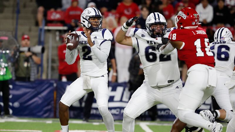 Nevada quarterback Brendon Lewis looks for a receiver during the first half of the team's NCAA...