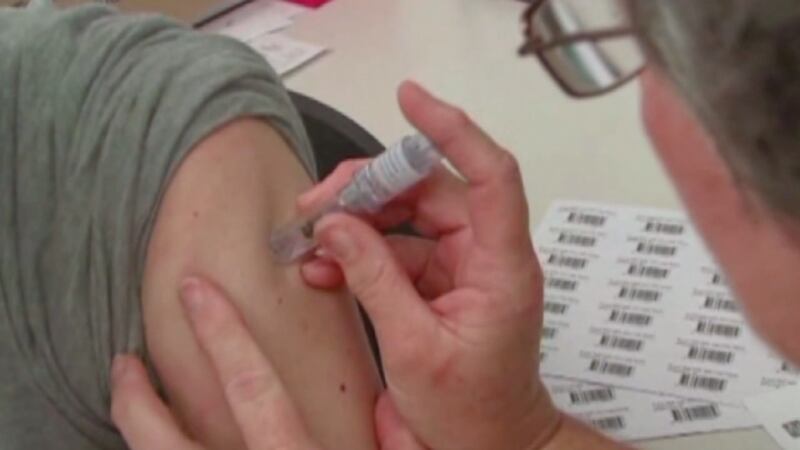 A woman receiving a flu shot.