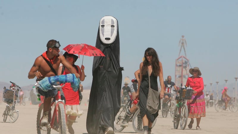 FILE - In this Aug. 28, 2008 file photo, Burning Man participants walk on the playa at the...