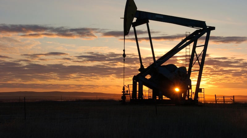 FILE - This Nov. 6, 2013 file photo shows a Whiting Petroleum Co. pump jack pulling crude oil...