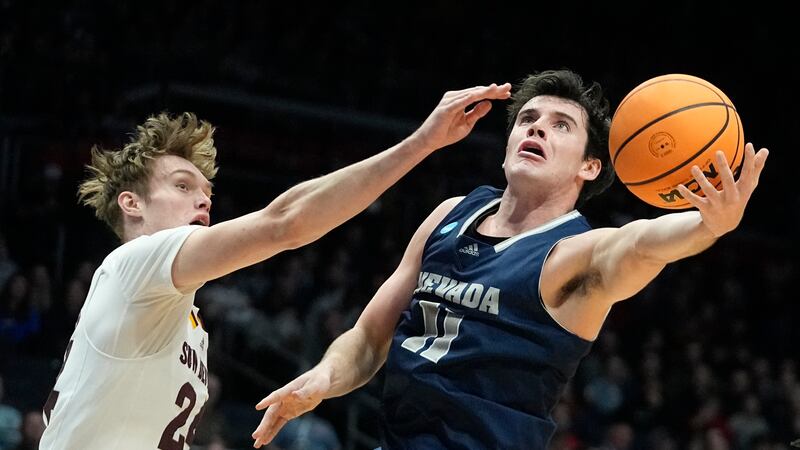 Nevada's Nick Davidson shoots against Arizona State's Duke Brennan during the first half of a...
