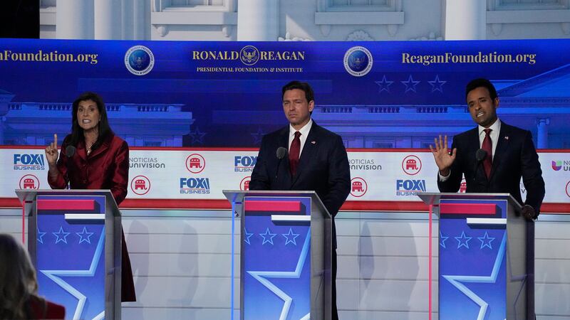 Former U.N. Ambassador Nikki Haley, left, argues a point with businessman Vivek Ramaswamy,...