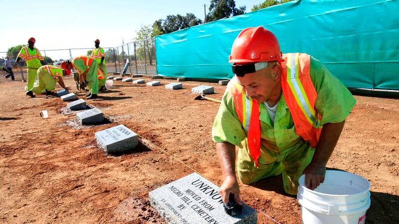 FILE - Steven Abujen, a California prison inmate with the Prison Industry Authority, cleans...