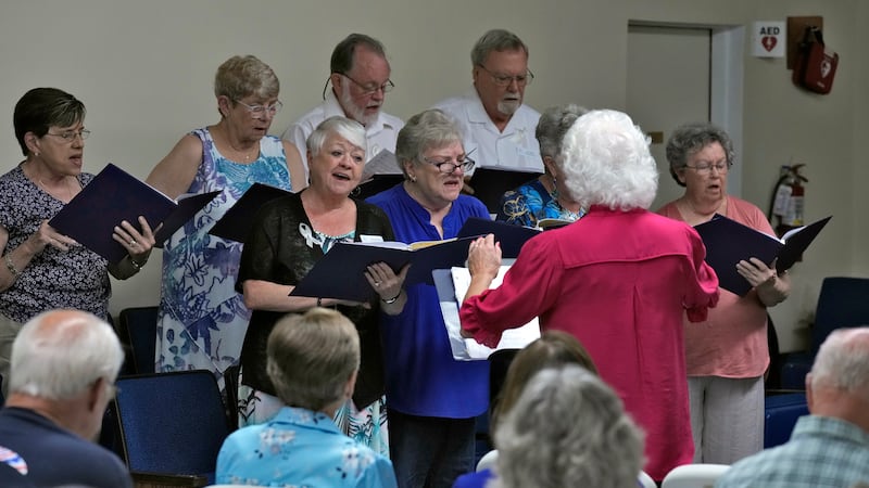 Members of the choir sings along with the congregation during service at the Grace Methodist...